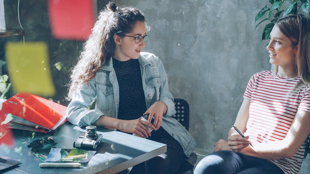 Two Brazilian coworkers having a calm respectful conversation at a table