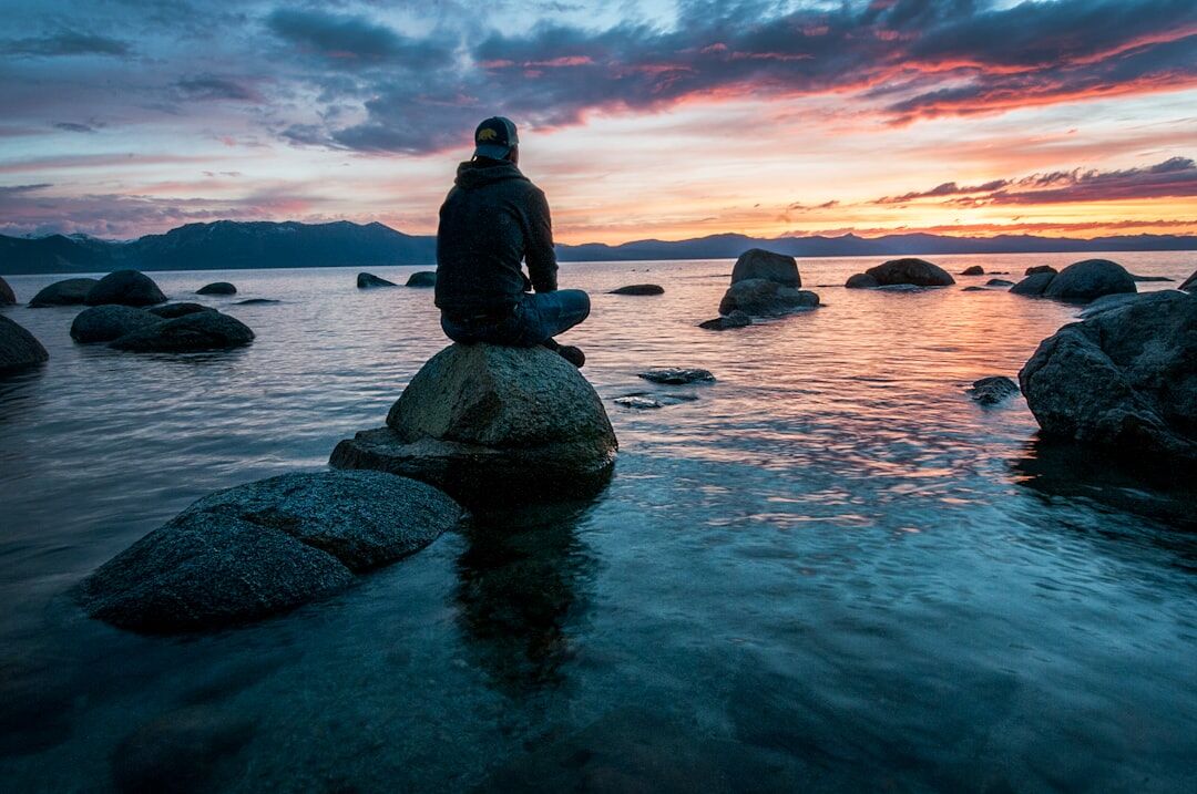 person meditating in nature