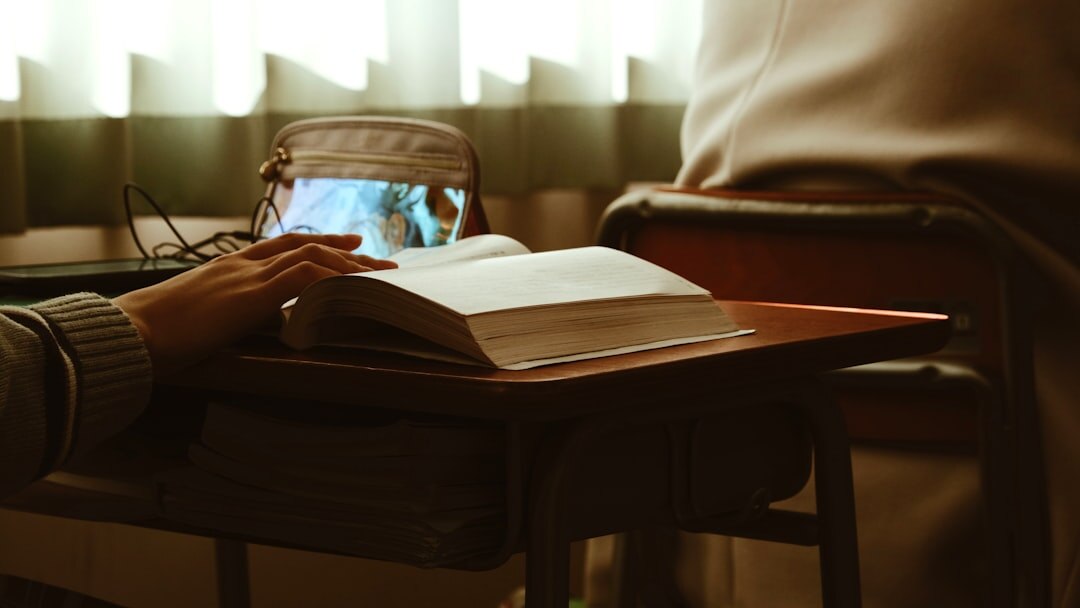 person reading book at desk