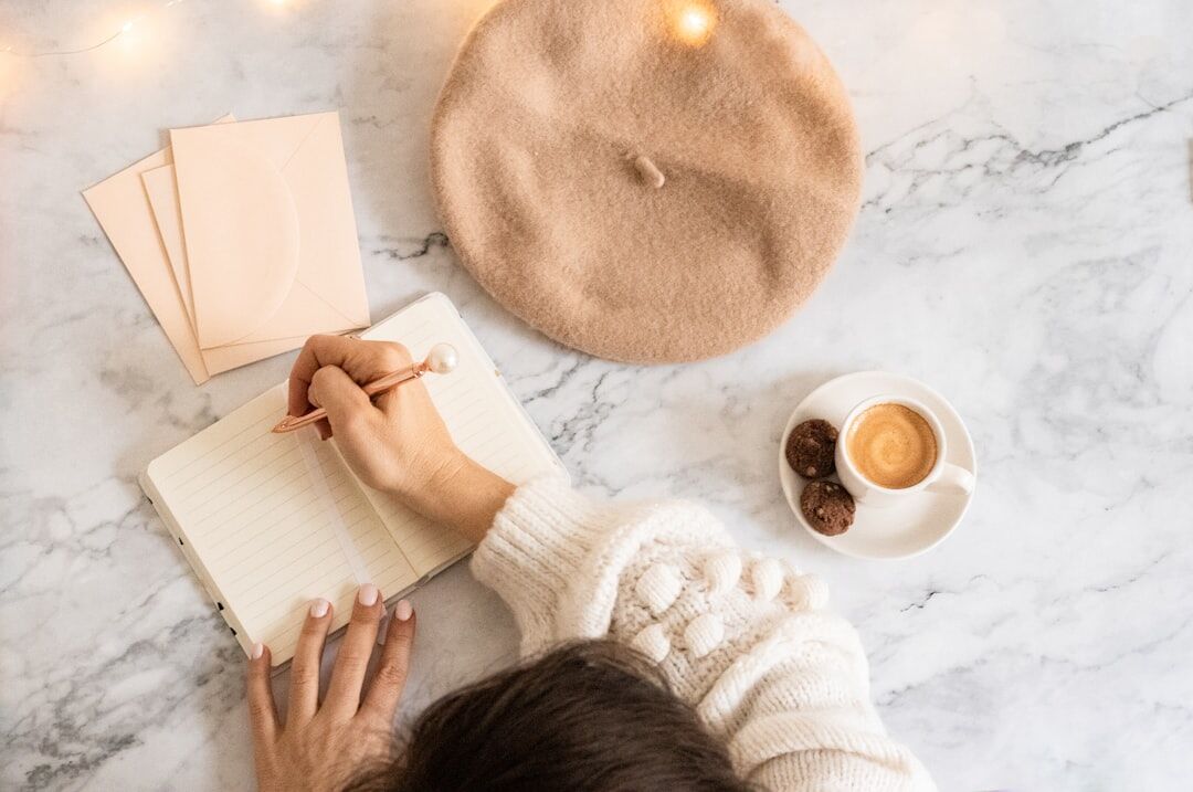 woman writing goals in journal