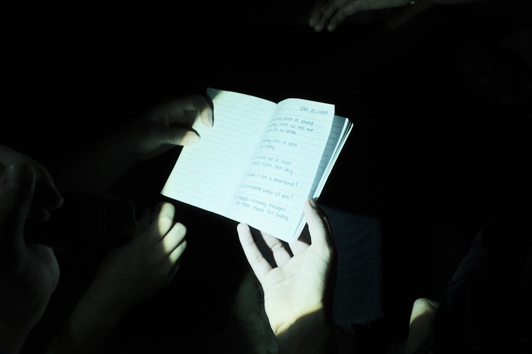 Circle of hands and notebooks during a group reflection exercise